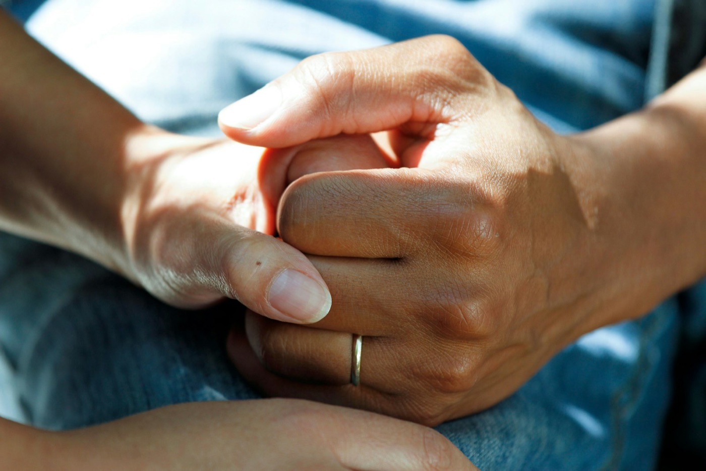 Caring hands holding a patient's hand