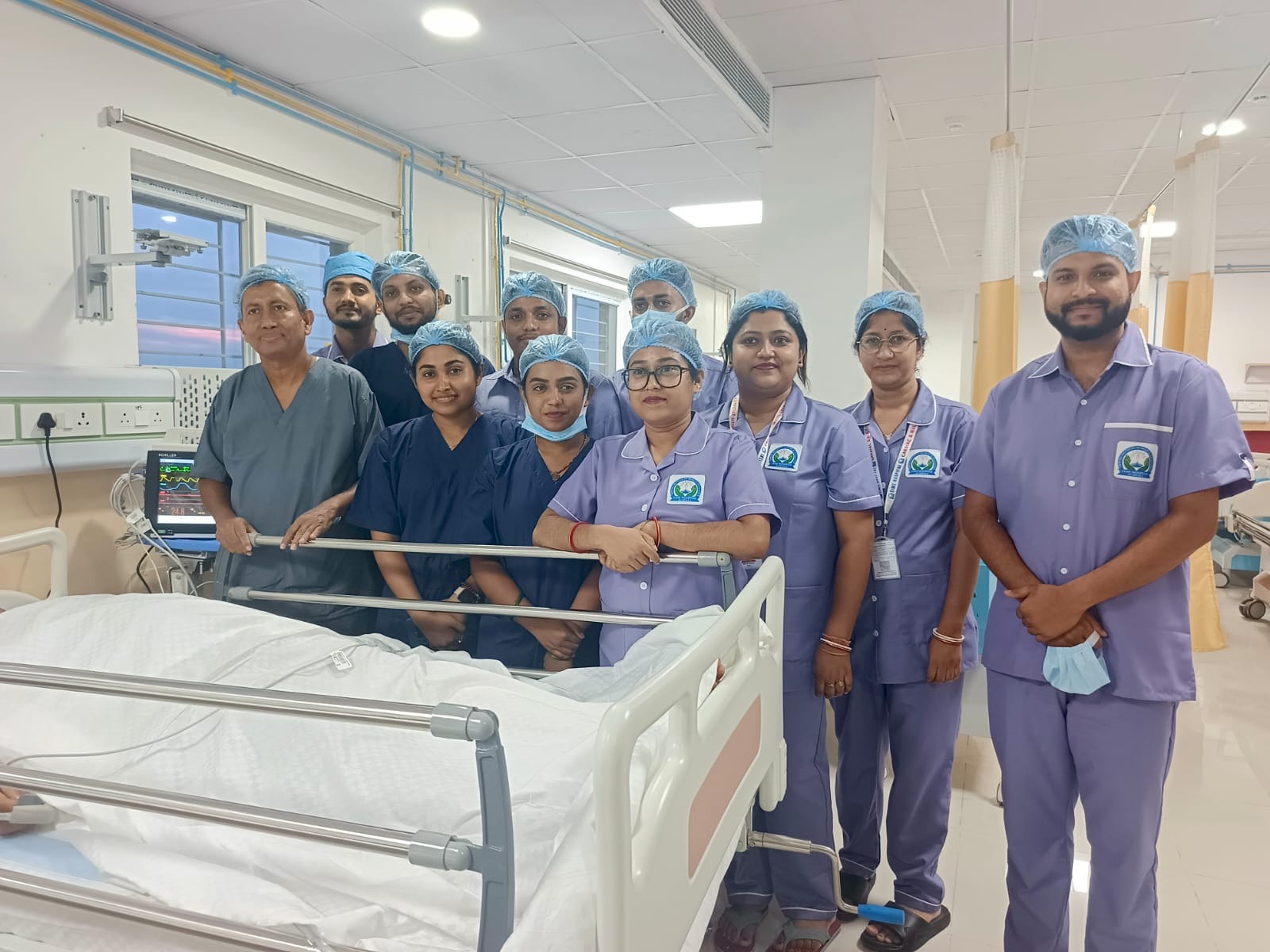 TIME Hospital doctors and nursing team beside a patient bed in the ward